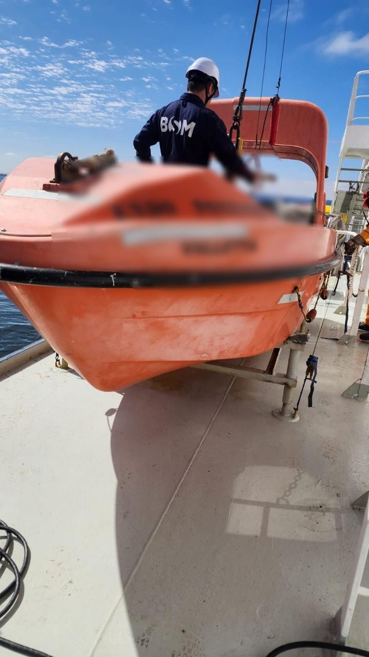 Technician working on lifeboat inspection equipment